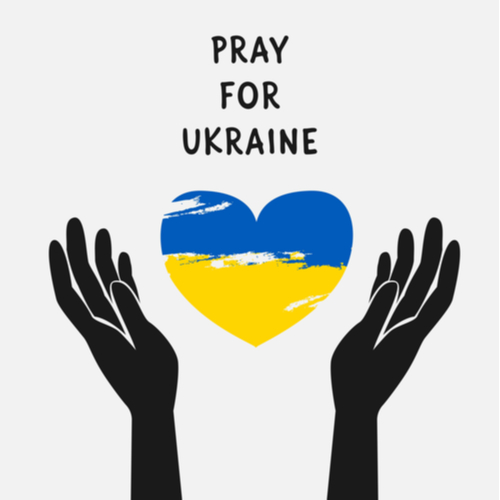 Praying for Ukraine - two hands around a Ukraine Heart shaped flag